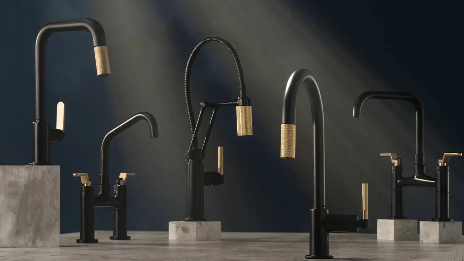 Row of matte black kitchen faucets with gold knurled handles displayed on concrete pedestals against a dark backdrop.